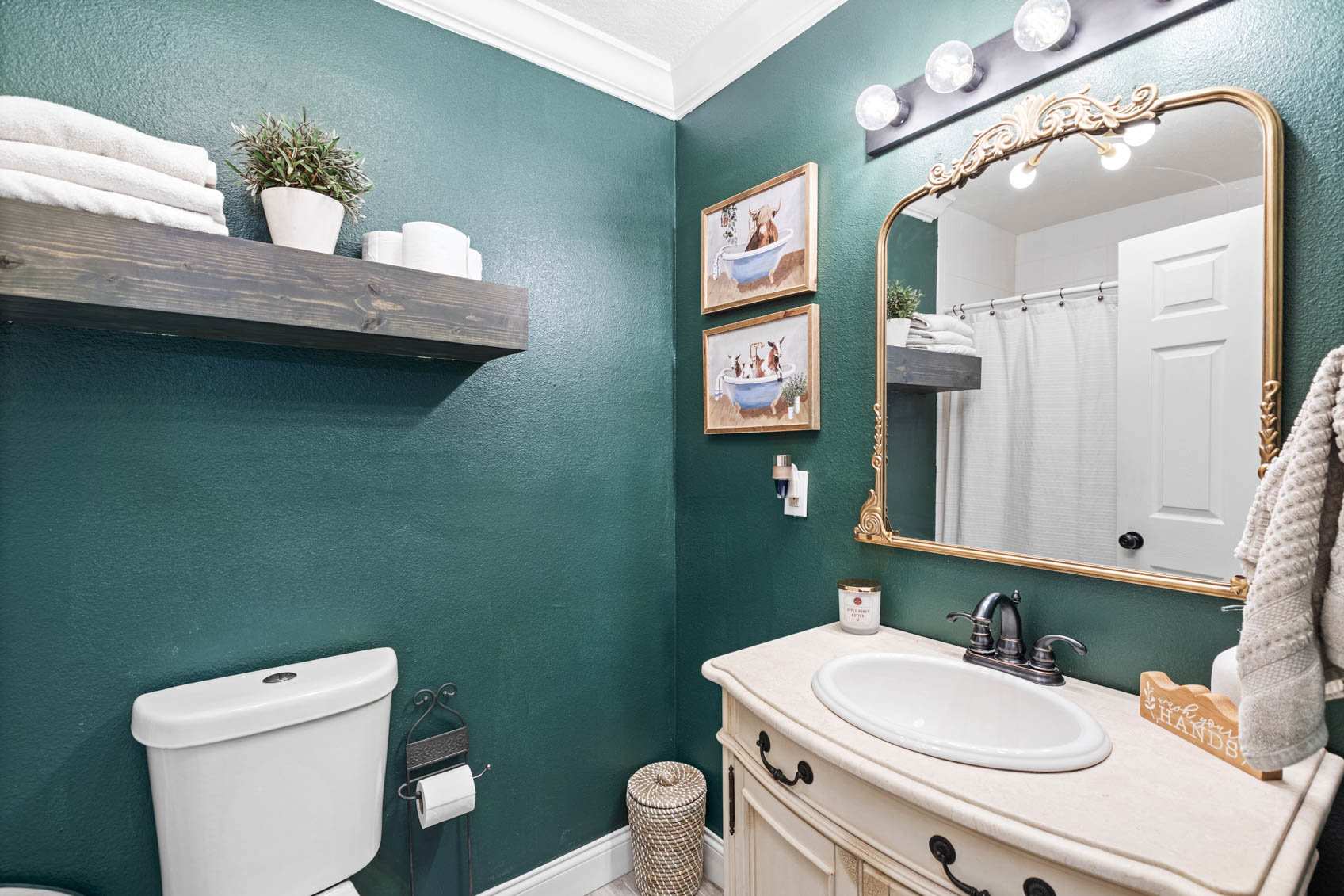 bathroom with green walls and white toilet